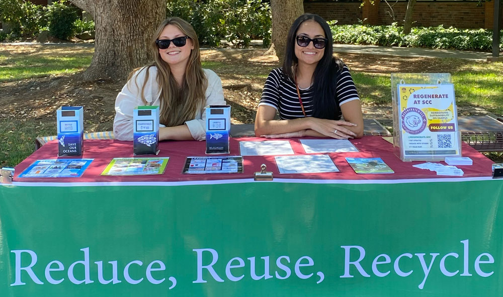 photo of Eden and Sophie at an informational table for Regenerate at SCC, Convocation Fall 2022