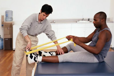 physical therapy professional assiting a patient with a resistance exercise