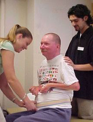 physical therapy professionals working with a patient