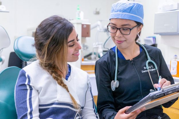 Becky Yang consulting with a dental patient