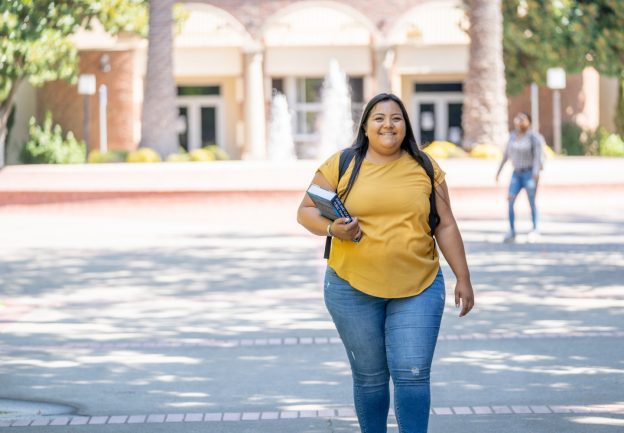 Susana Barraza smiling in front of the SCC fountain