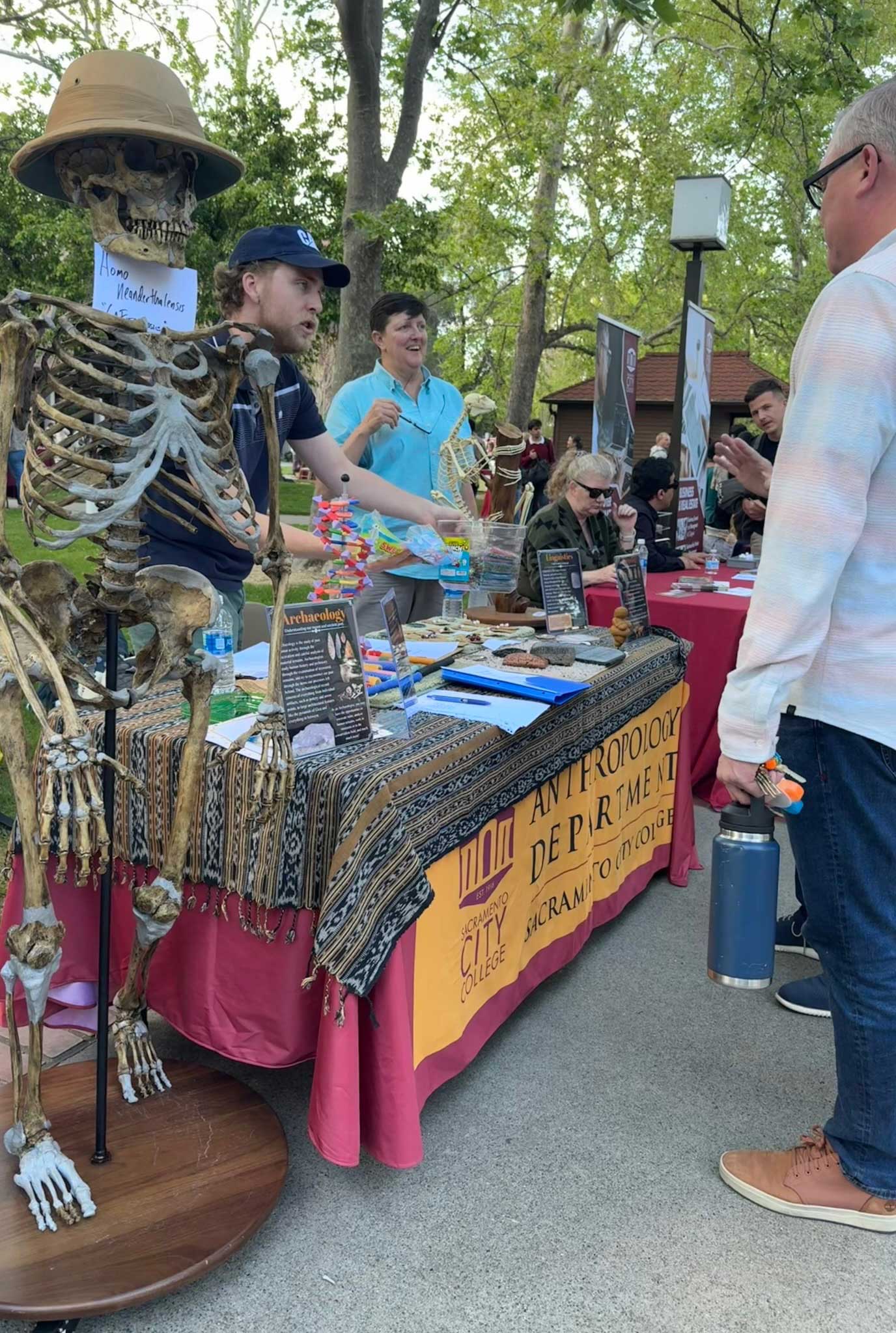photo of a student talking with a visitor in the quad during an event