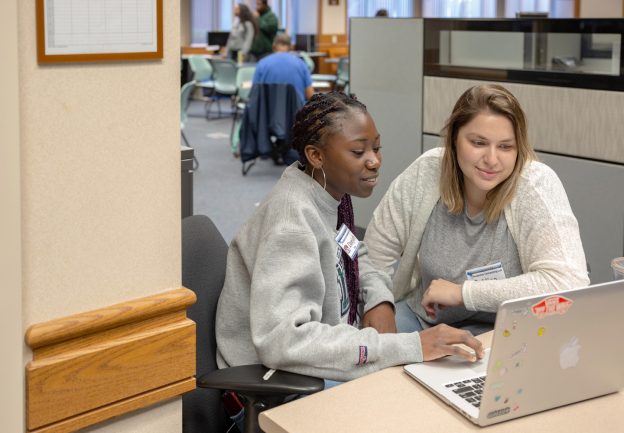 student worker helping another student with tech support