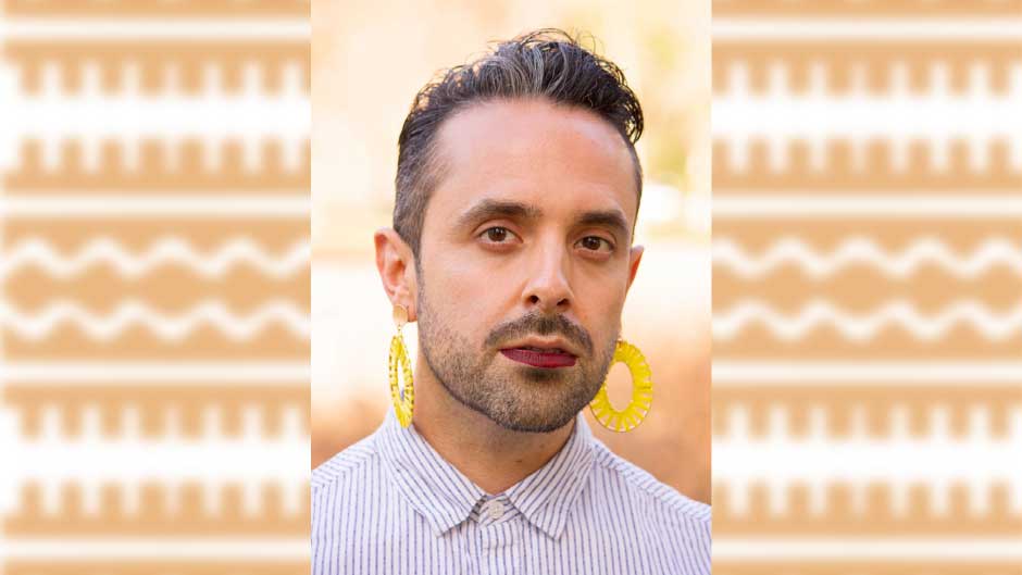 Photo of Assistant Professor Roberto Chacon-Gutiérrez Young on an orange and white patterned and slightly blurred background