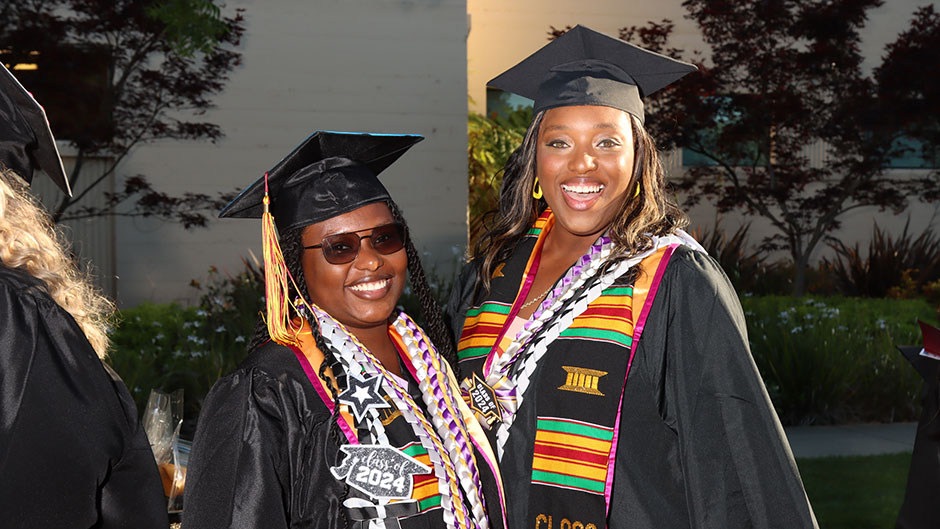 photo of two Black women graduates who are in SCC ommencement regalia