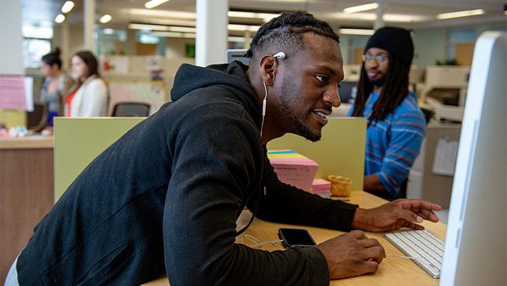Student on campus looking at a computer