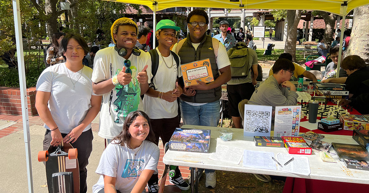 Jack of All Trades students at an outside booth