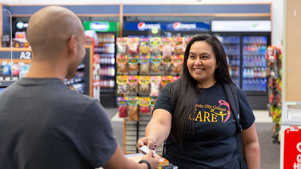 CARE student purchasing supplies at the college store with a card