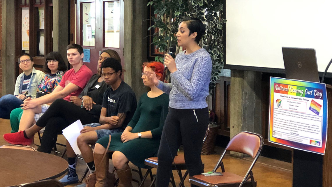 National Coming Out Day standing speaker and seated panel