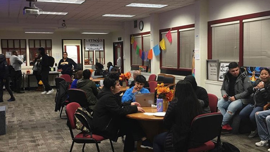 RASA Center students gathered at tables on campus in the Center