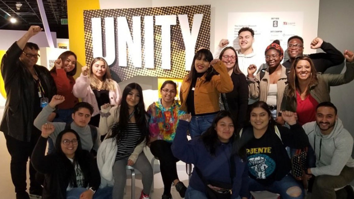 RASA Center students group photo with fists raised in solidarity