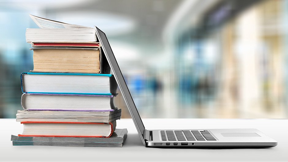 Books and a laptop on a table