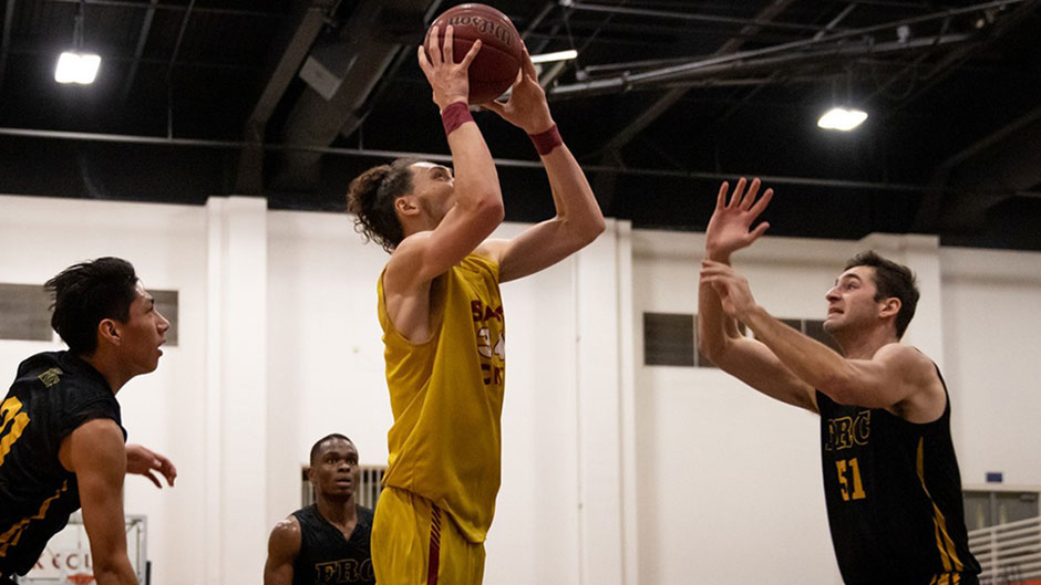 Basketball player jumping in the air to shoot the ball