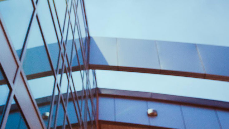 Artistic shot of a glass ceiling and metal beams