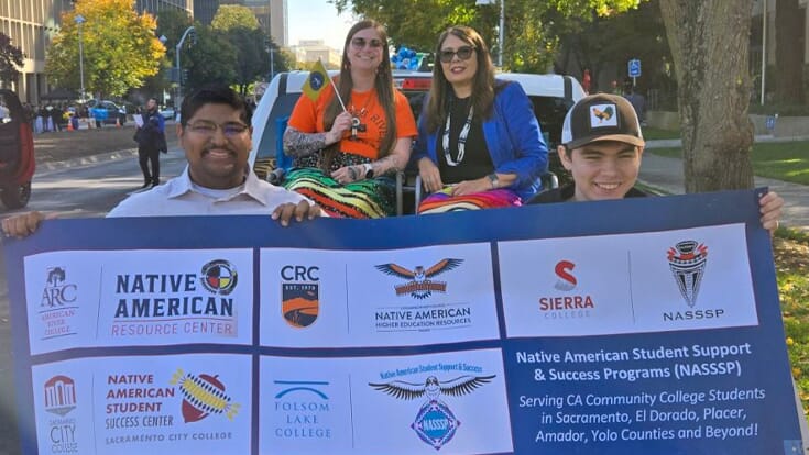 group of students holding sign