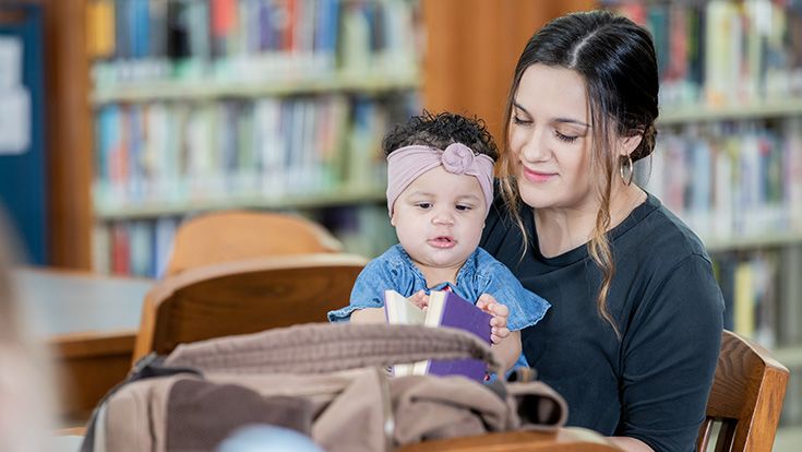 Mother with young daughter in the library