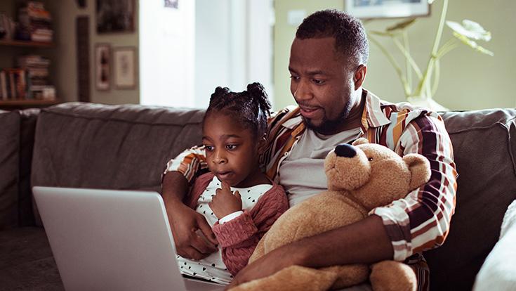 Dad helping his daughter with schoolwork