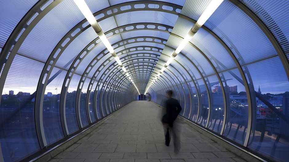 London, England walking across the glass bridgeway at night